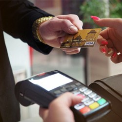 Man handing woman credit card